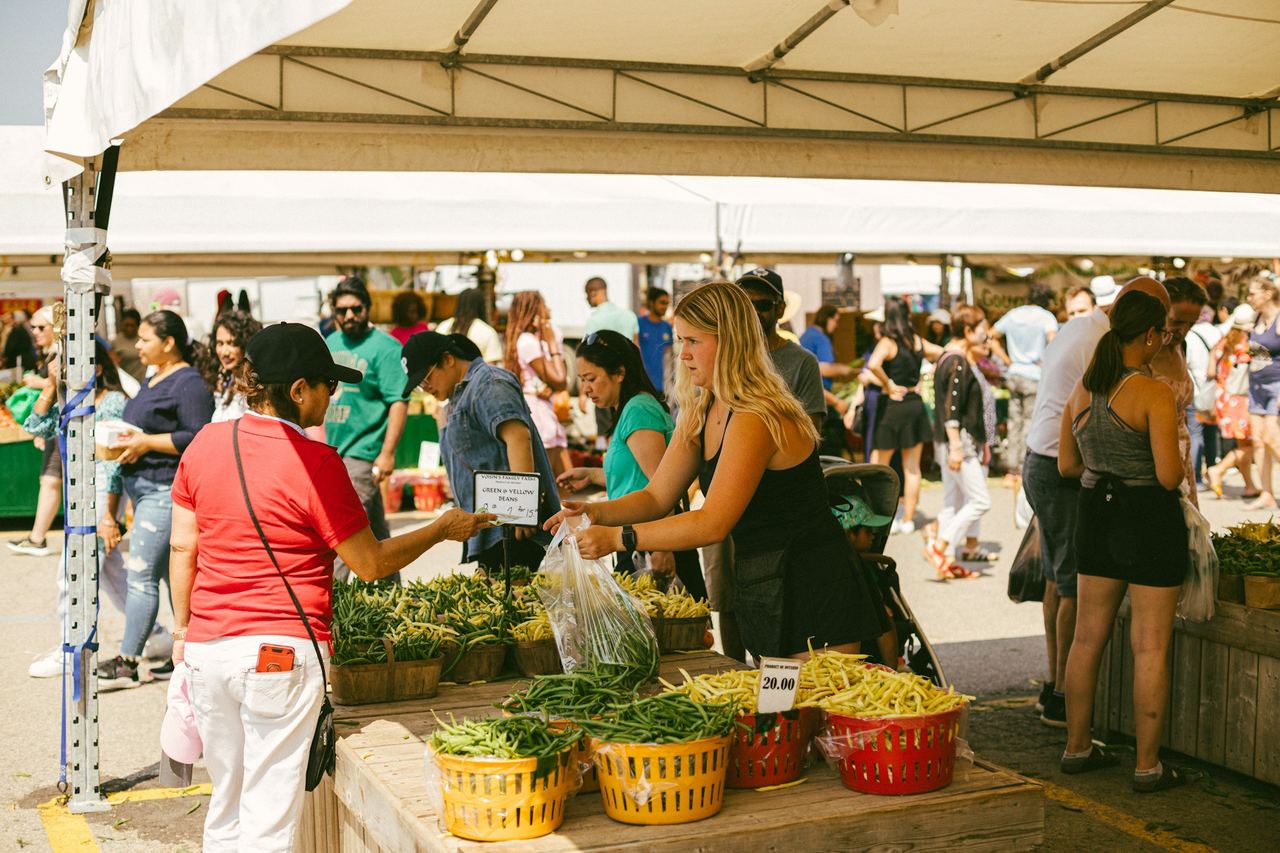 People shopping for fresh produce at an outdoor market