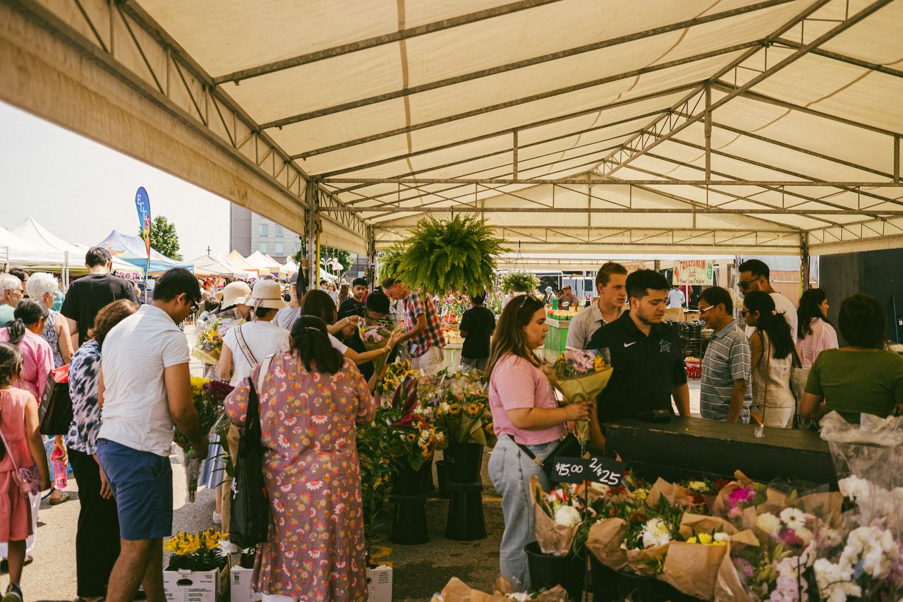 People browsing flowers at an outdoor market
